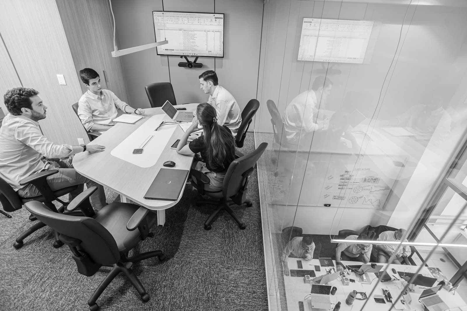 Executive team reviewing a search pipeline in a conference room